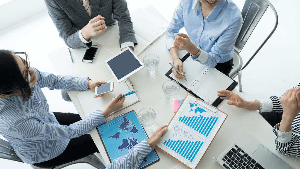 grupo de trabajadores en una empresa teniendo una reunión positiva. La reunión trata sobre el retorno social y empresarial de la inclusión